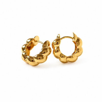 Pair of shiny 18K gold plated croissant huggie hoop earrings made of waterproof stainless steel for women.