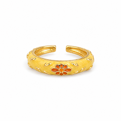 Marigold Bloom Enamel Ring in gold-tone stainless steel featuring butter yellow enamel and an orange floral design, adjustable, waterproof, anti-tarnish, lightweight, and hypoallergenic.