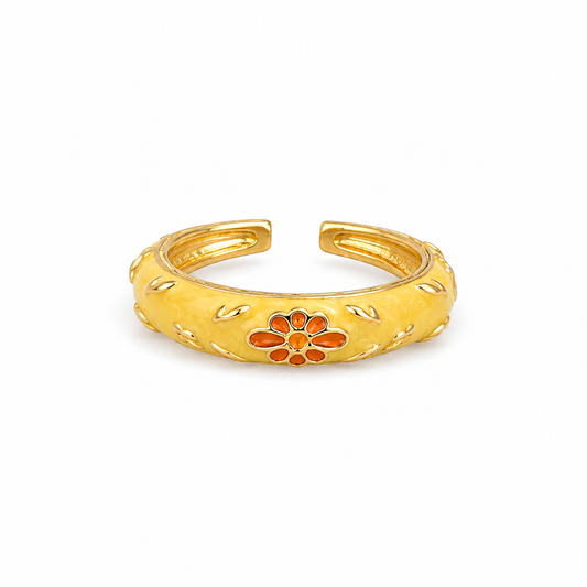Marigold Bloom Enamel Ring in gold-tone stainless steel featuring butter yellow enamel and an orange floral design, adjustable, waterproof, anti-tarnish, lightweight, and hypoallergenic.
